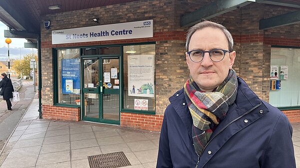 Ian standing in front of St Neots Health Centre