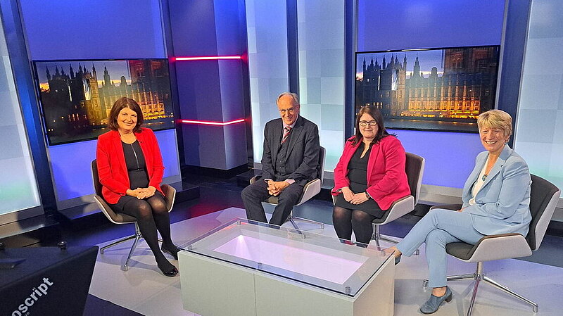 Pippa Heylings in the ITV Anglia Politics studio, sitting next to two other panelists and the presenter