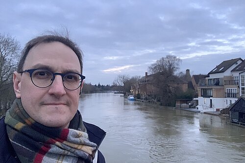 Ian Sollom standing in front of the river in St Neots