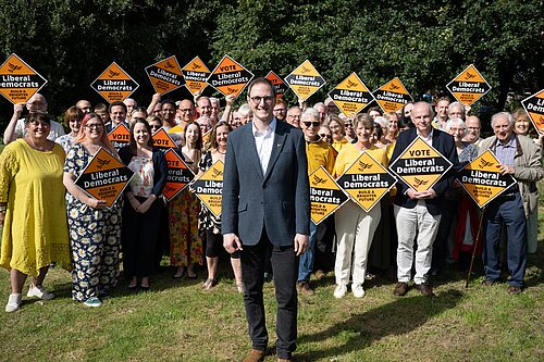 Ian Sollom, pictured at his launch event in August 2023 with a crowd of Liberal Democrat volunteers in the background