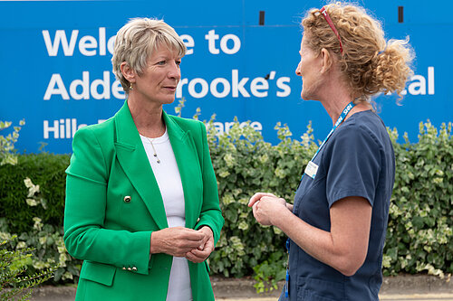 Pippa Helylings talking to a member of NHS medical staff outside Addenbrookes Hospital