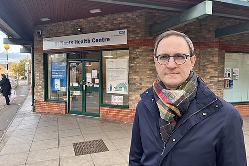 Ian standing in front of St Neots Health Centre