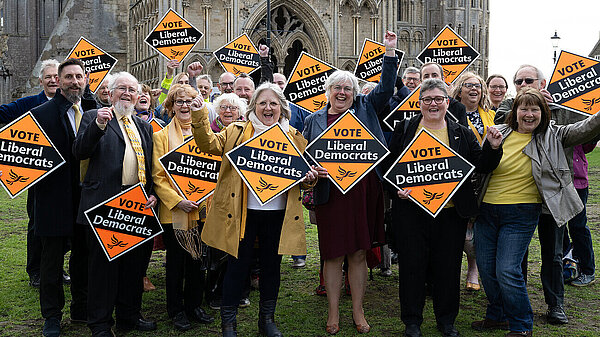 A group of Lib Dem campaigners standing in front of Ely Cathedral. Charlotte Cane, parliamentary candidate for Ely and East Cambs, is standing in the centre.