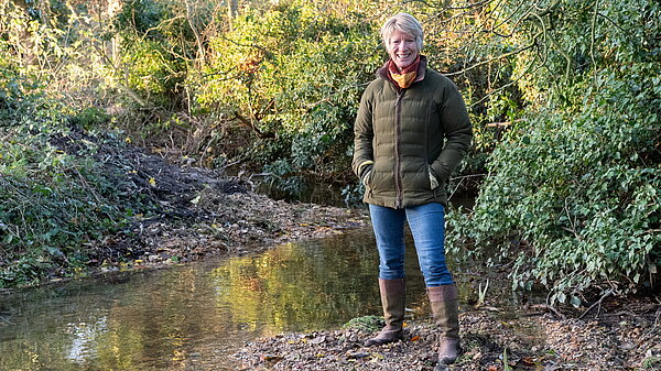 Pippa Heylings standing by a chalk stream