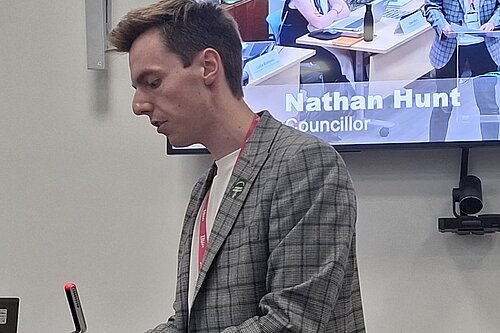 Cllr Nathan Hunt speaking at a podium